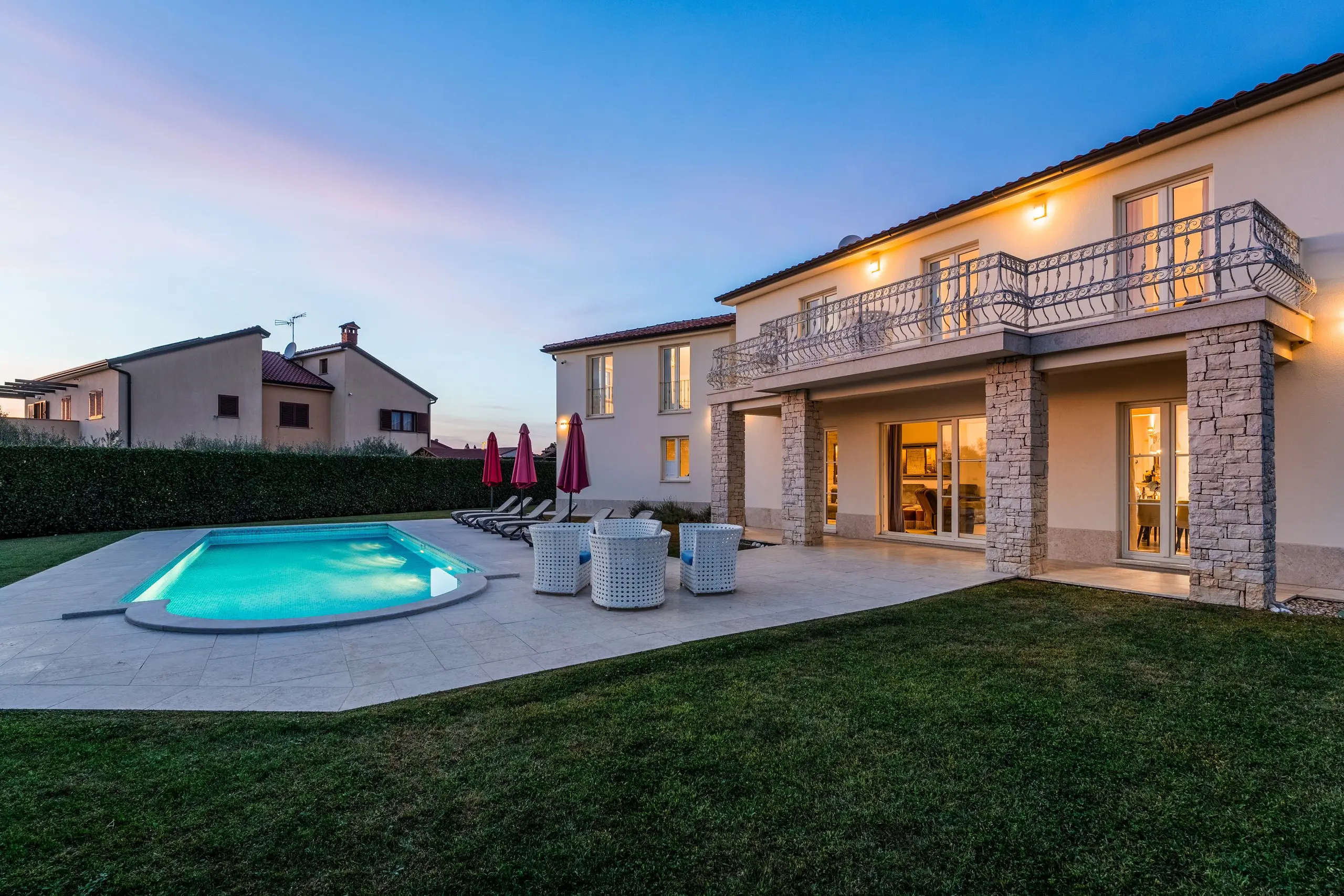 Villa Bina: the villa and pool lit up at dusk
